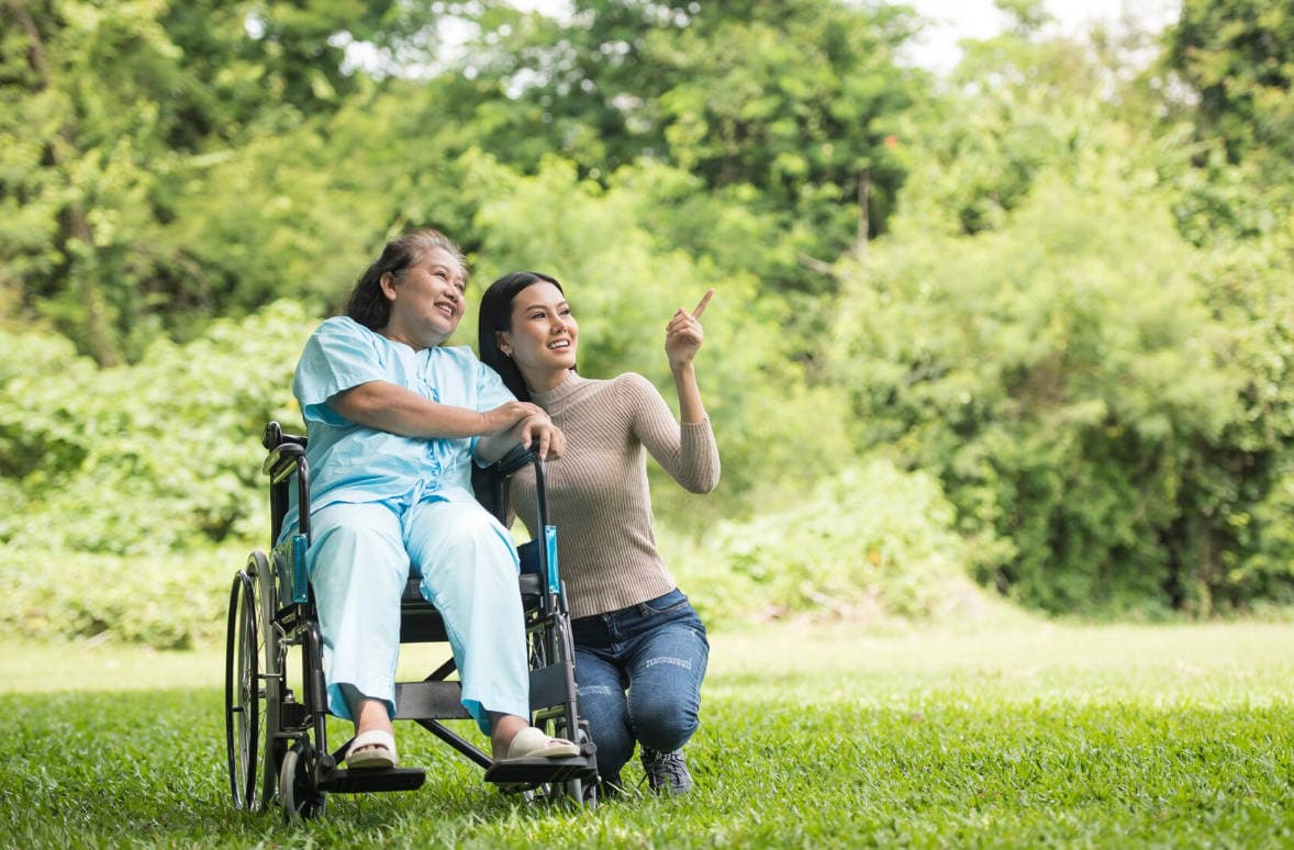 Support worker with elderly woman in wheelchair